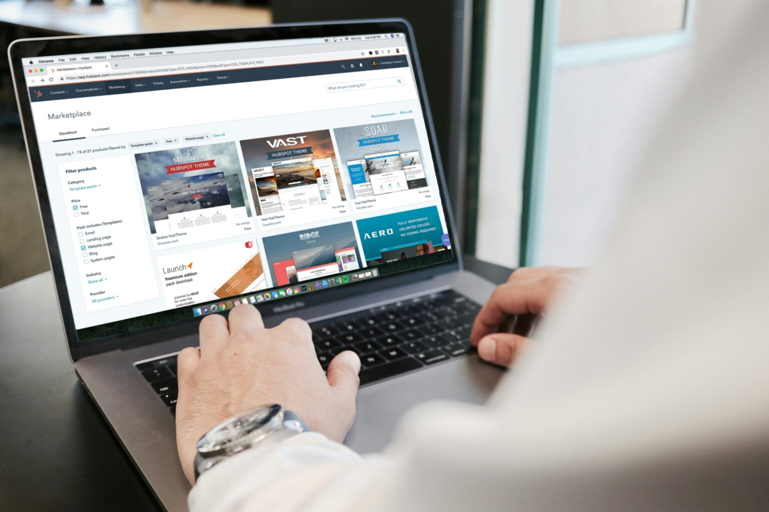 A human typing on a laptop